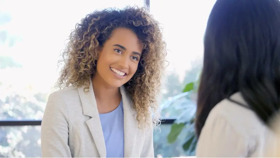 A person smiling at another person