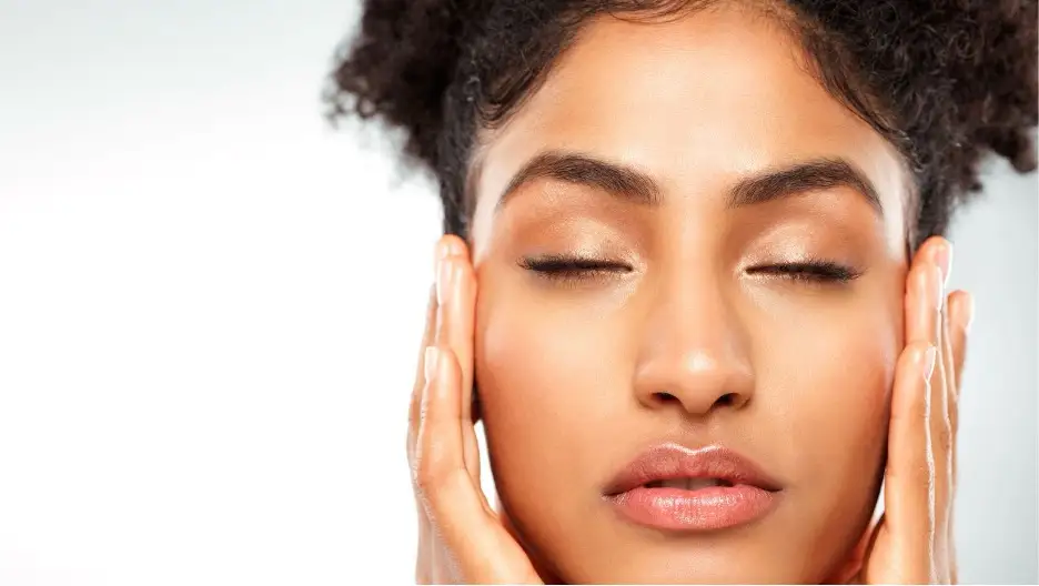 A close-up of a person with her eyes closed