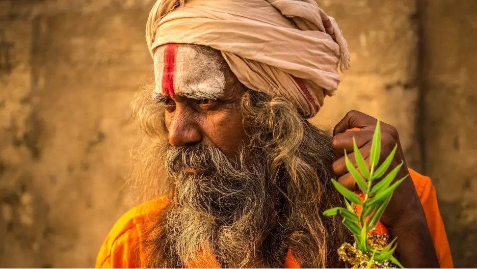 A person with long beard and a turban