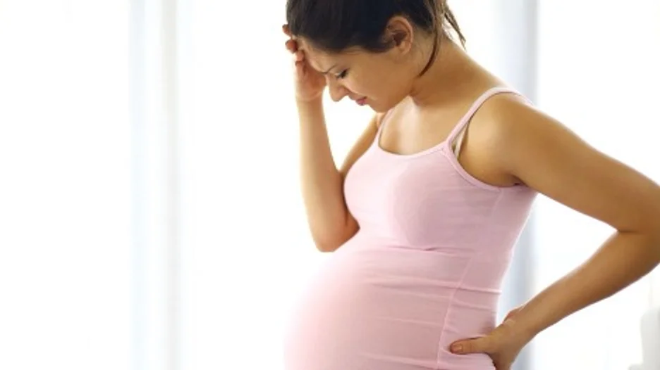 Pregnant woman holding her belly