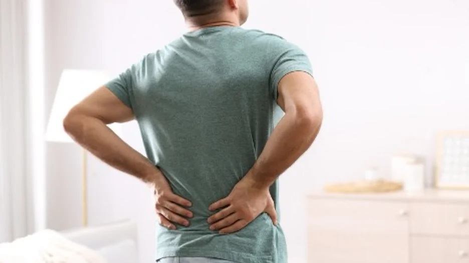 A person holding his back