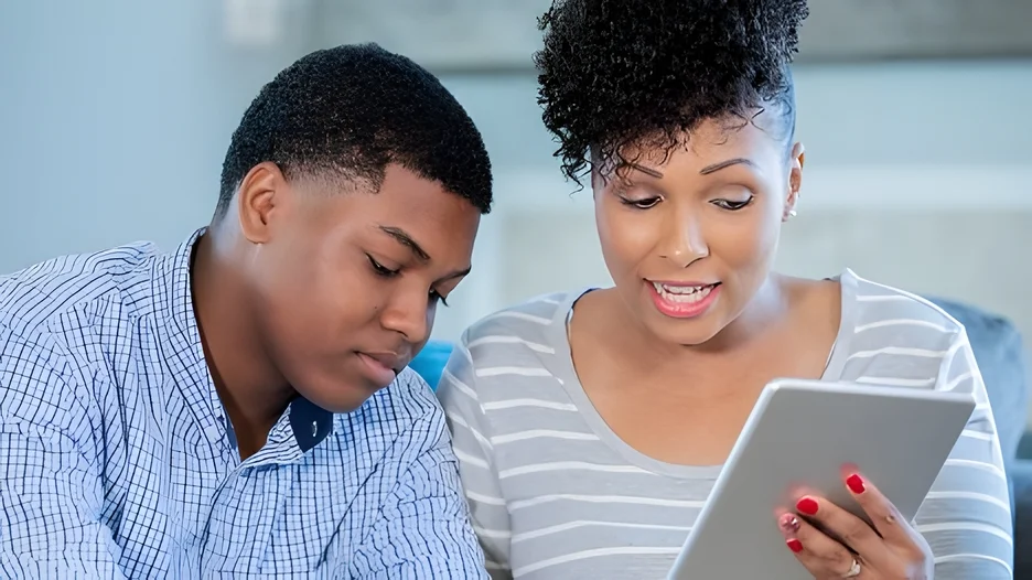 Two people looking at a tablet