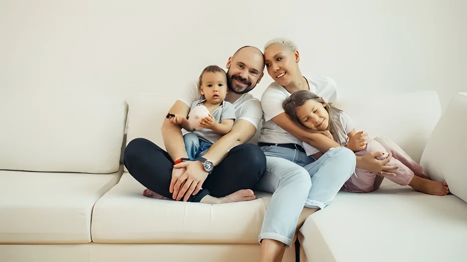 A family sitting on a couch