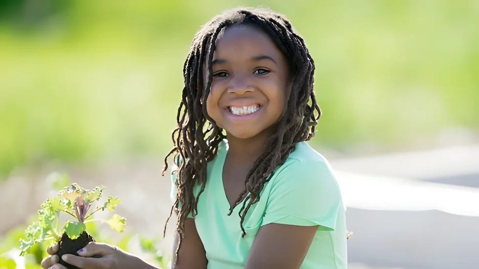 A young child smiling at the camera