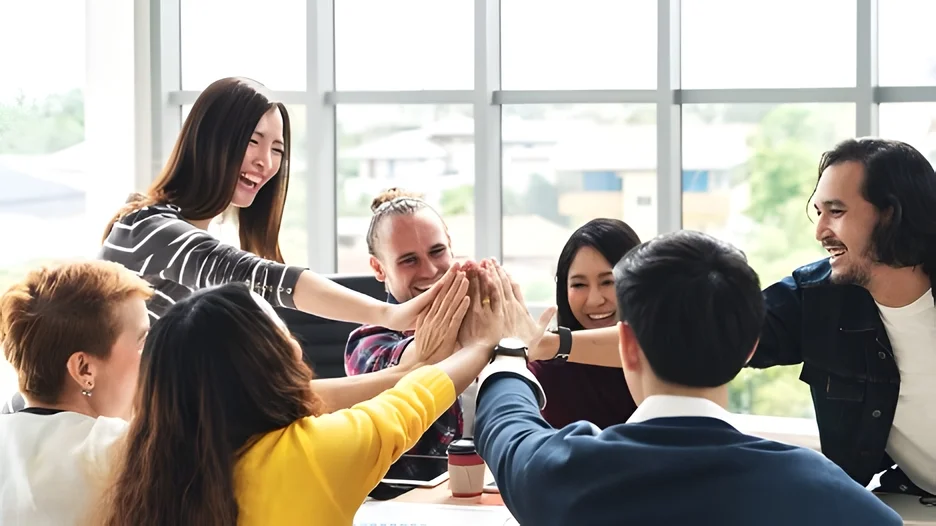 A group of people giving each other a high five