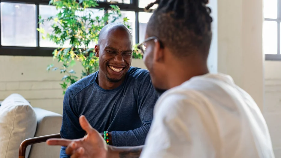 Two people smiling and talking to each other