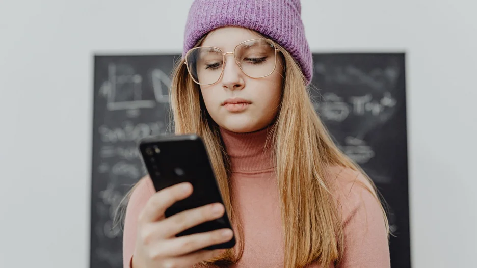 Young woman looking at her cell phone